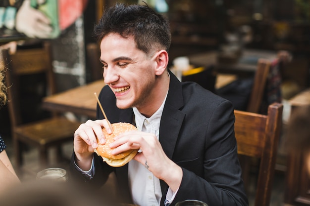 Man eating and laughing in restaurant