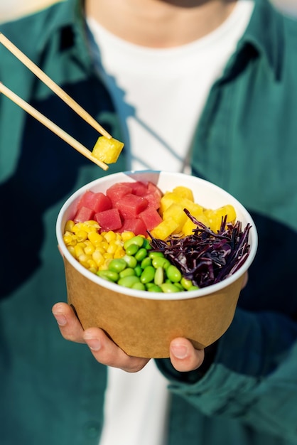 Free photo a man eating a poke