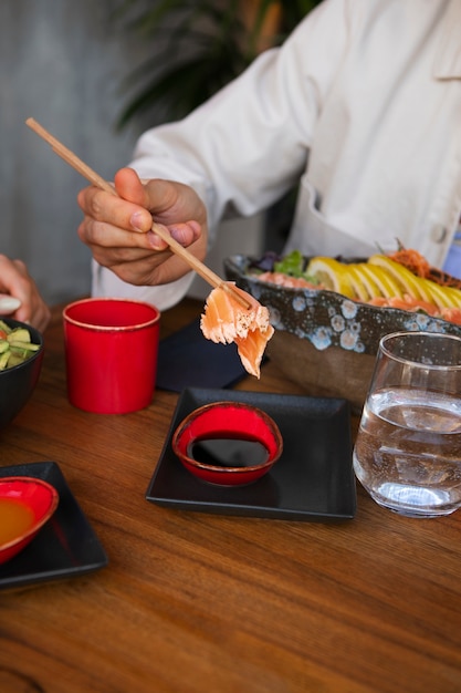 Free Photo man eating salmon dish bowl at the restaurant