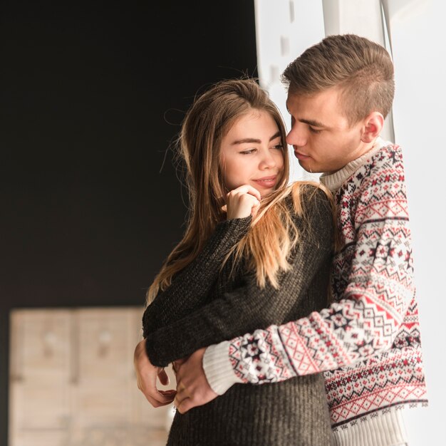 Man embracing her girlfriend from the behind