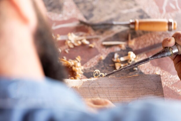 Man engraving in wood alone