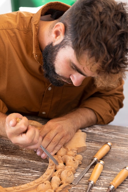 Free Photo man engraving in wood outdoors