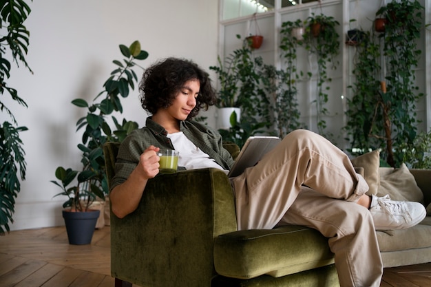 Free photo man enjoying a cup of matcha tea