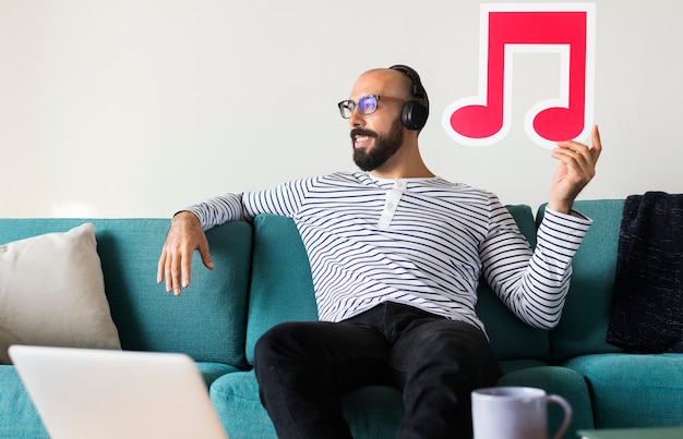 Free Photo man enjoying music at home