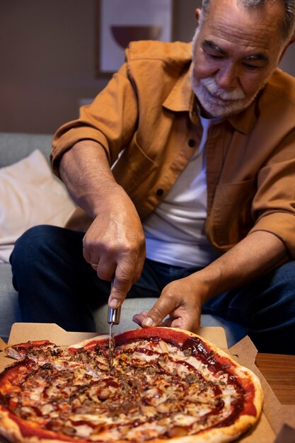 Man enjoying a pizza while being home alone