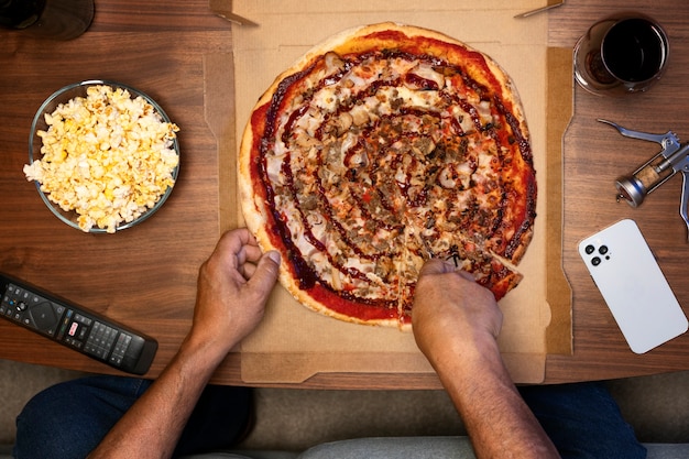 Man enjoying a pizza while being home alone