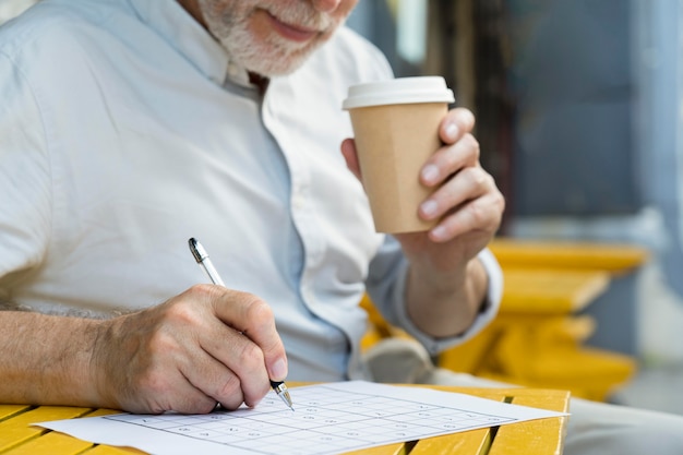 Man enjoying a sudoku game on paper by himself