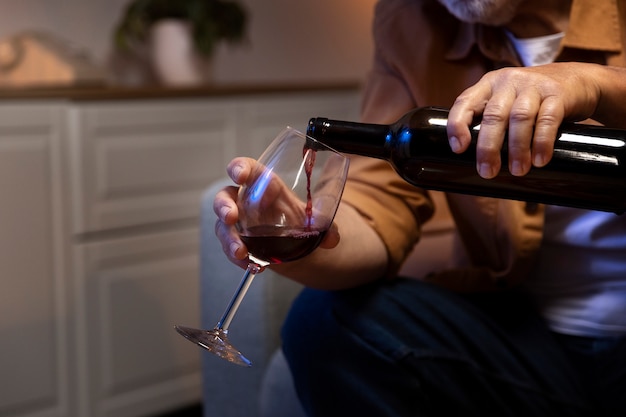 Man enjoying wine while being home alone