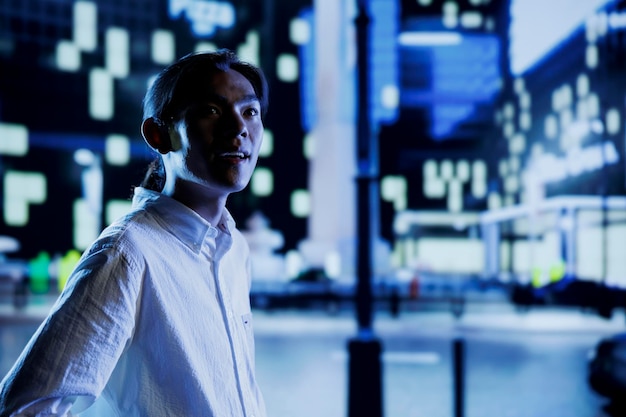 Free photo man enjoys city skyscrapers at night