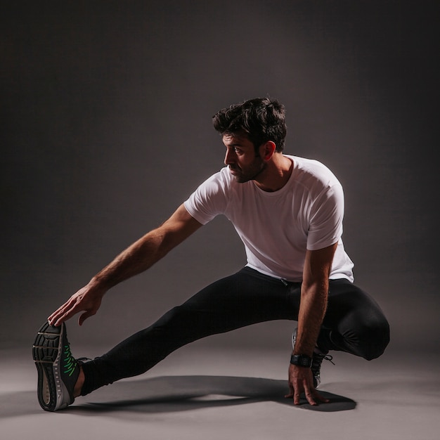 Man exercising on dark background