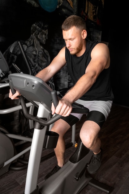 Free Photo man exercising at gym full shot