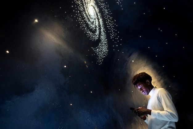 Free photo man experiencing the universe at a planetarium