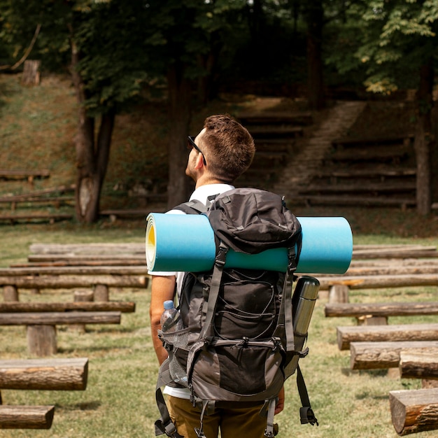 Free Photo man exploring park with benches