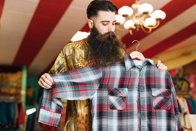 Man in a fashionable shop checking plaid shirt