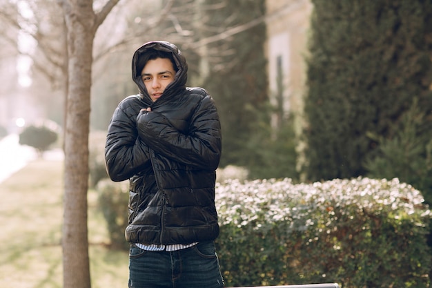 Free Photo man feeling cold in the black winter jacket in the park. high quality photo