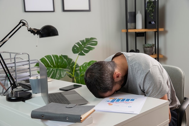 Man feeling sleepy while working from home