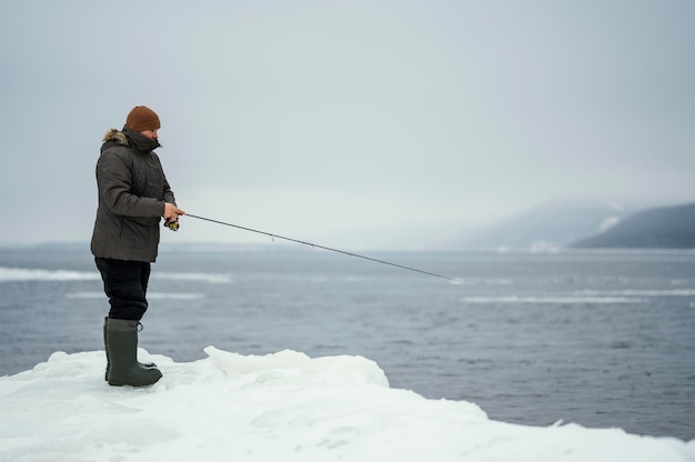 Free Photo man fishing with special equipment