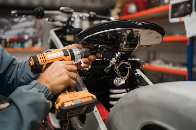 Man fixing a motorcycle in a modern workshop