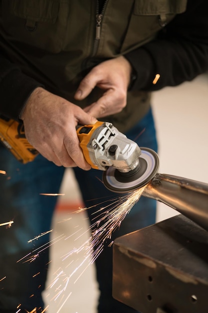 Free photo man fixing a motorcycle in a modern workshop