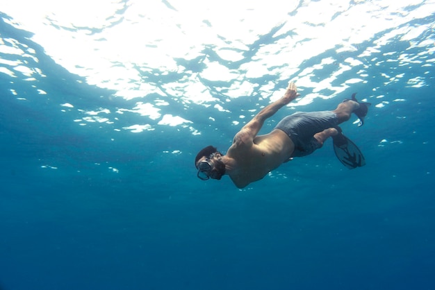 Man freediving with flippers underwater