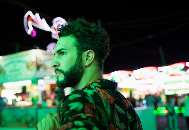 Man at funfair looking away