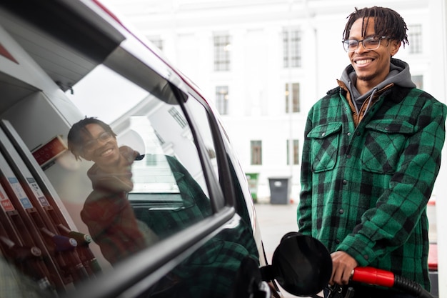 Free photo man at gas station with the car