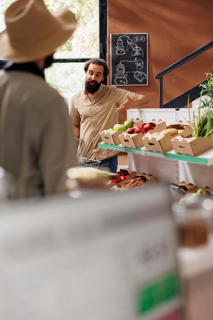 Free Photo man gestures curiously in grocery store