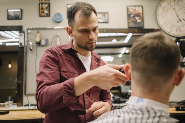 Free Photo man getting a haircut at a barbershop