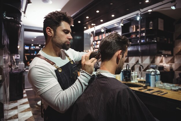 Man getting his hair trimmed with trimmer