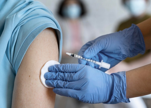 Free Photo man getting vaccine shot by medic