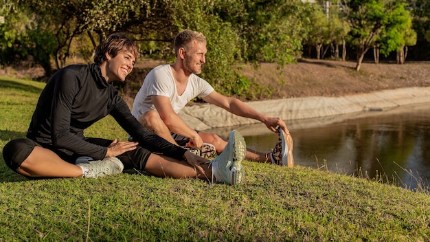 Man and girl doing warm-up in the park.