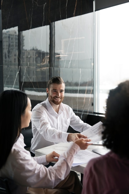 Man giving his workmates a document