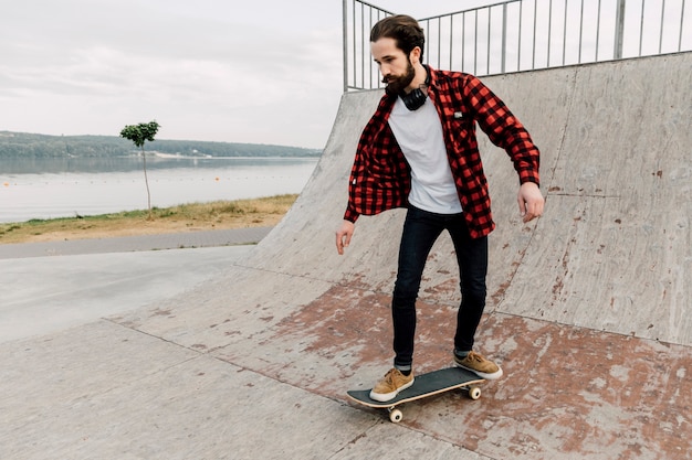 Man going on a ramp at skate park