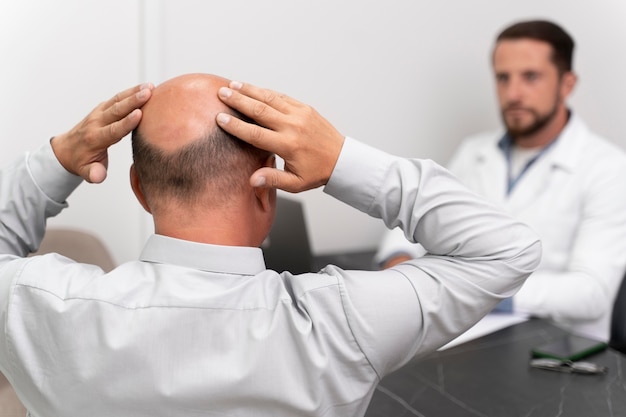 Man going through a follicular unit extraction process