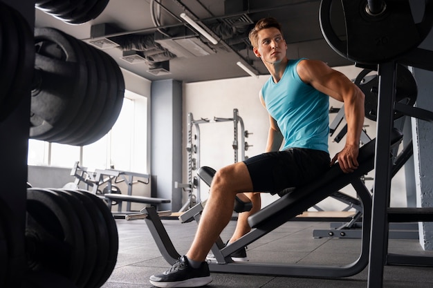 Man in the gym doing body building exercises