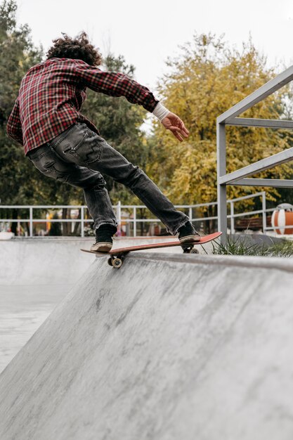 Man having fun with skateboard in the park