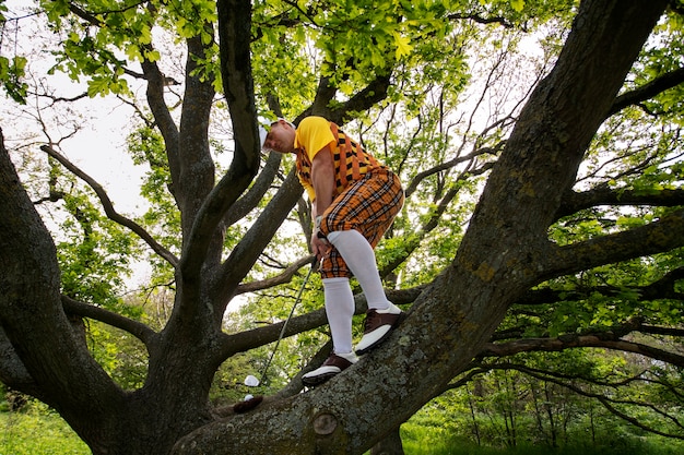 Free photo man having a game of golf outdoors on the field