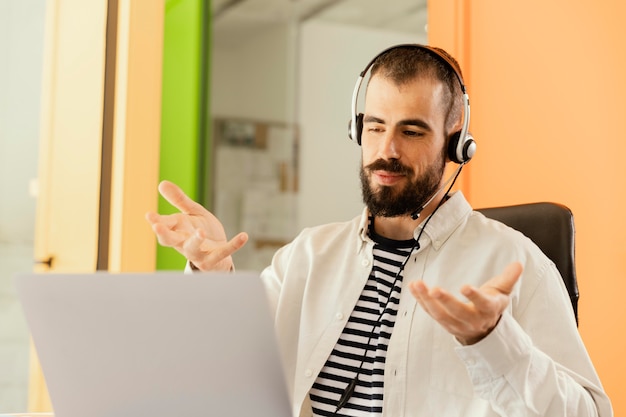 Free photo man having an online meeting for work