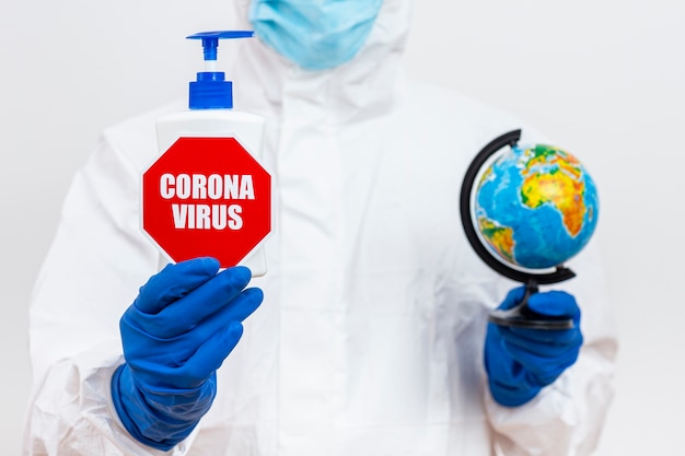 Free Photo man in hazmat suit with coronavirus stop sign