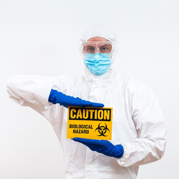 Man in hazmat suit with danger sign