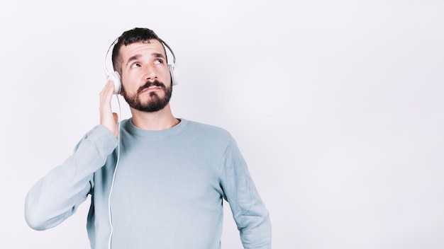 Free photo man in headphones looking up