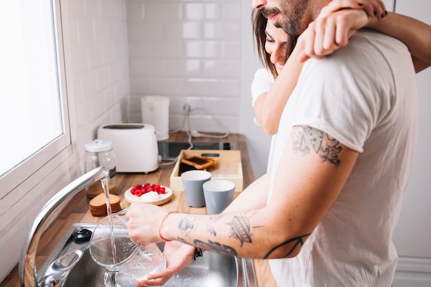 Man helping woman with dishes