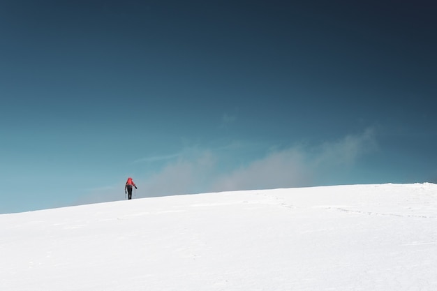 Man hiking on the mountains covered in snow