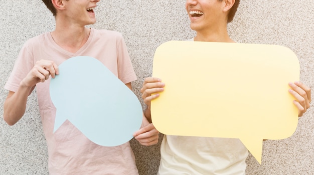 Man and his friends holding speech bubbles