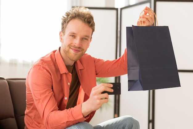 Man holding bag and credit card