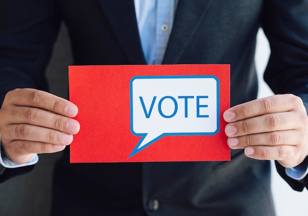 Man holding a ballot with a voting message