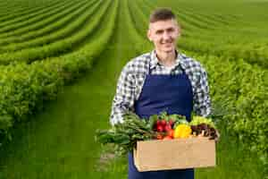 Free photo man holding basket with vegetables