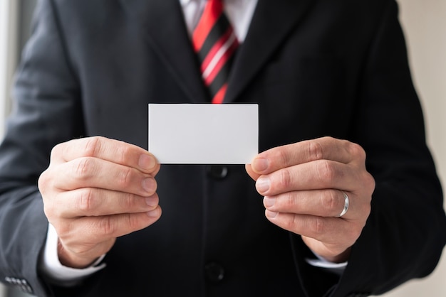 Free Photo man holding blank business card