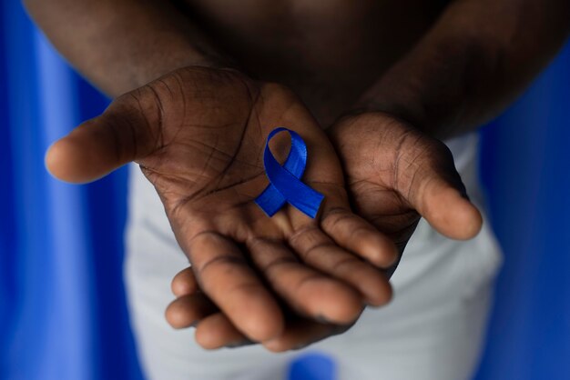 Man holding a blue ribbon