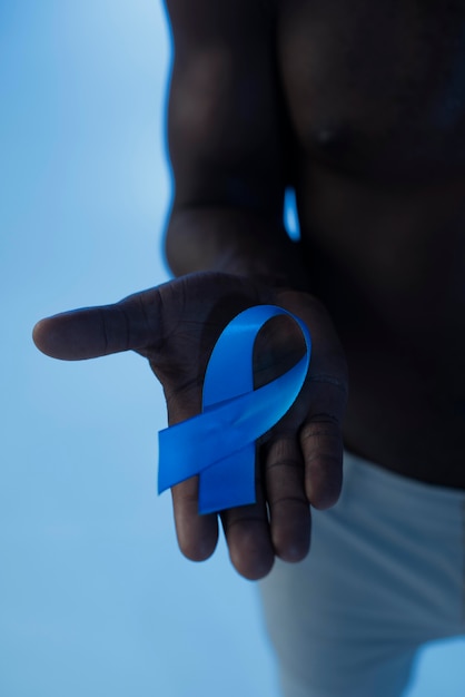 Man holding a blue ribbon